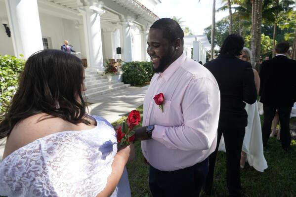 Couple exchange marriage vows shop
